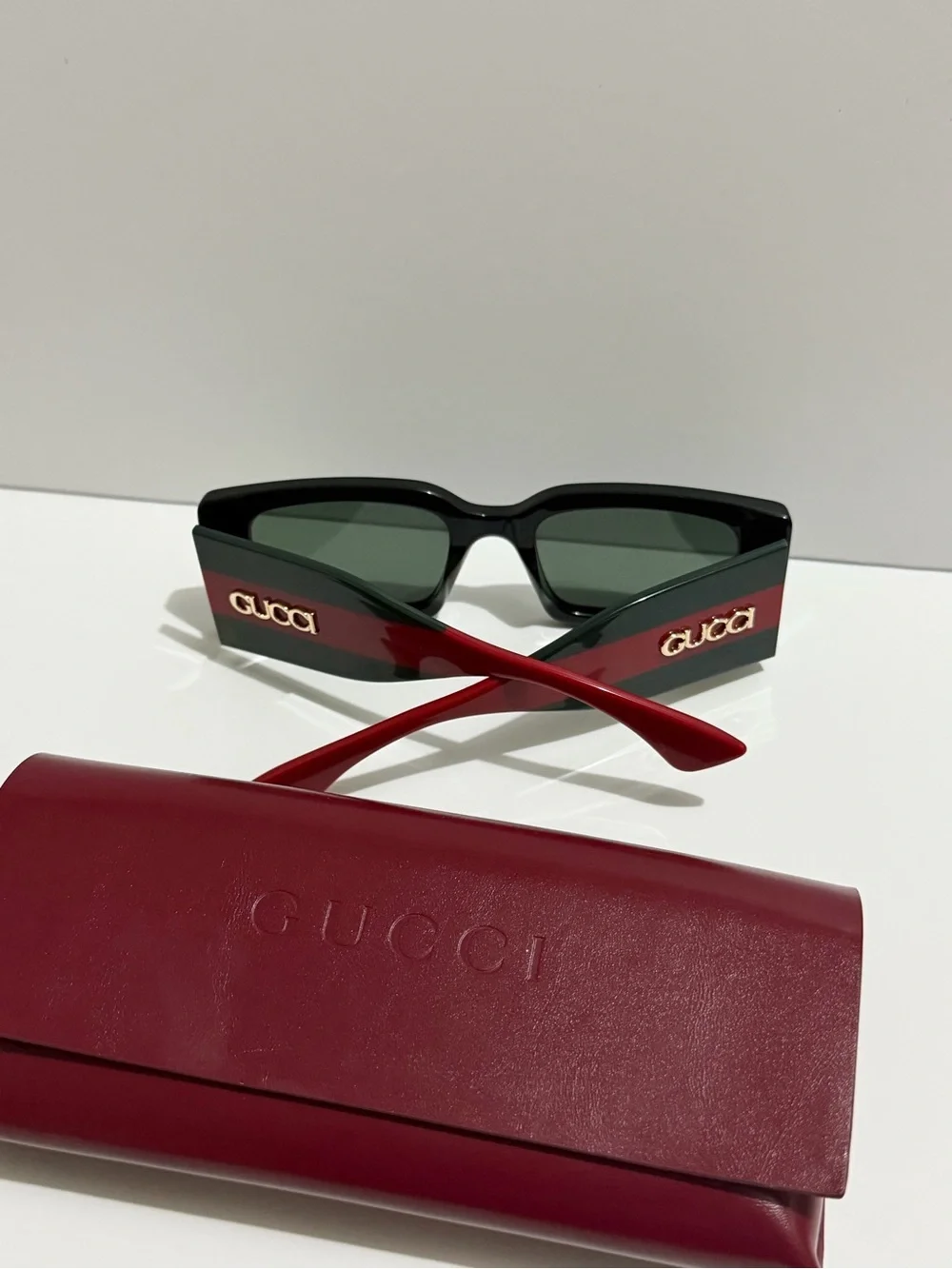 Gucci Black Frame Sunglasses with Red Temples and Gold Logo